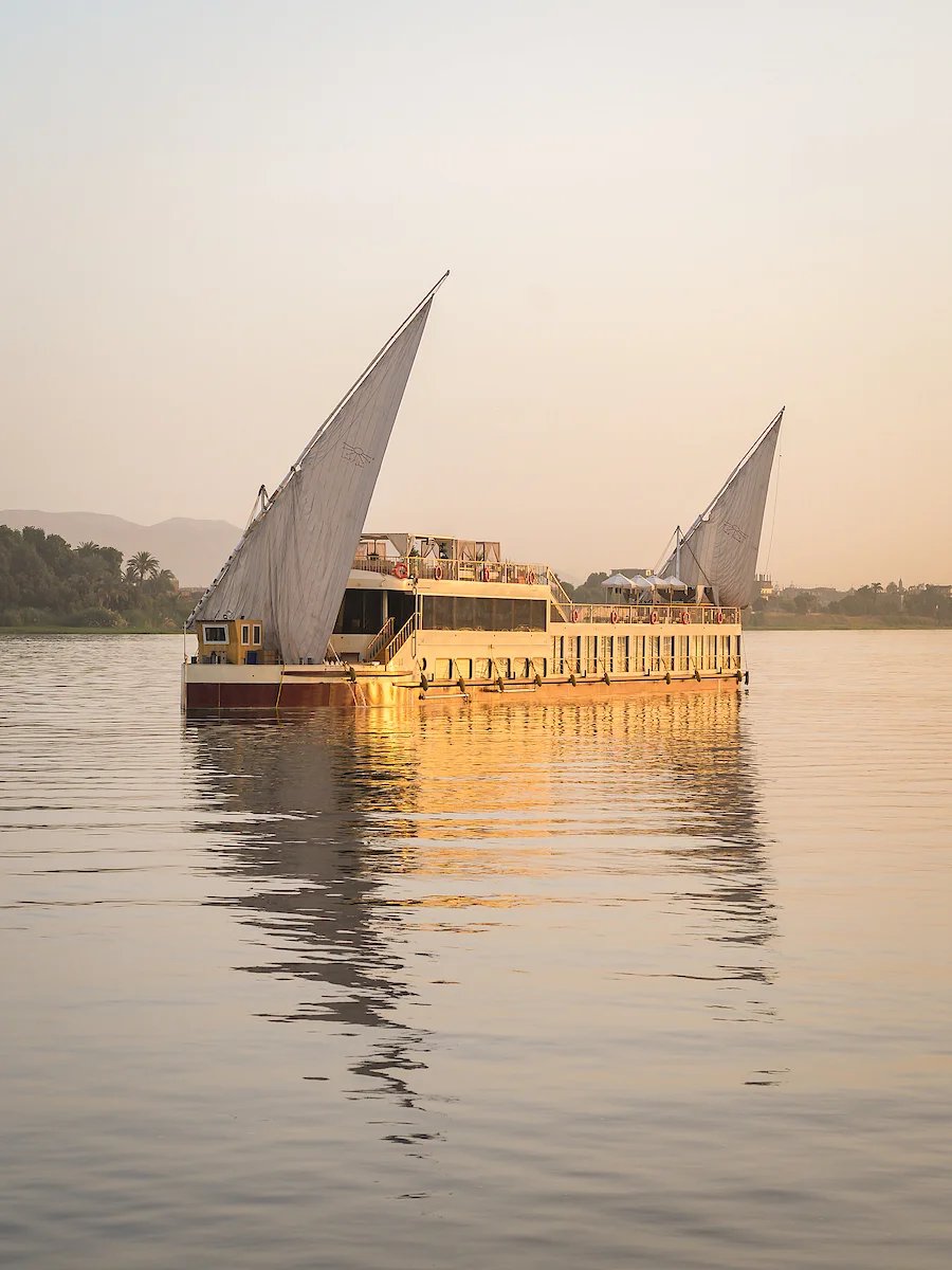 A dahabiya on the Nile at golden hour