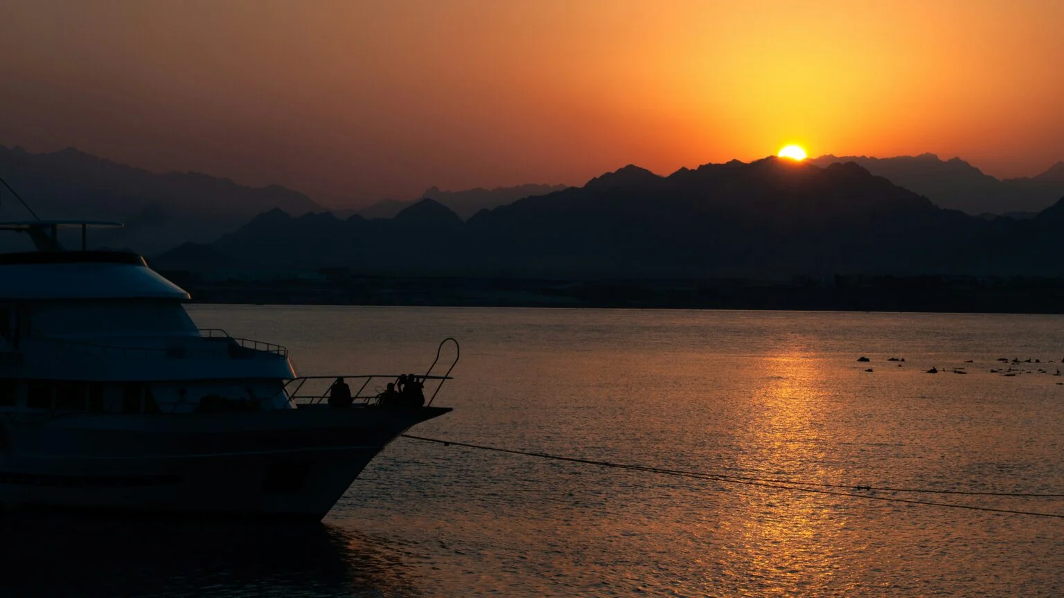 Dusk over the Red Sea, a boat silhouette