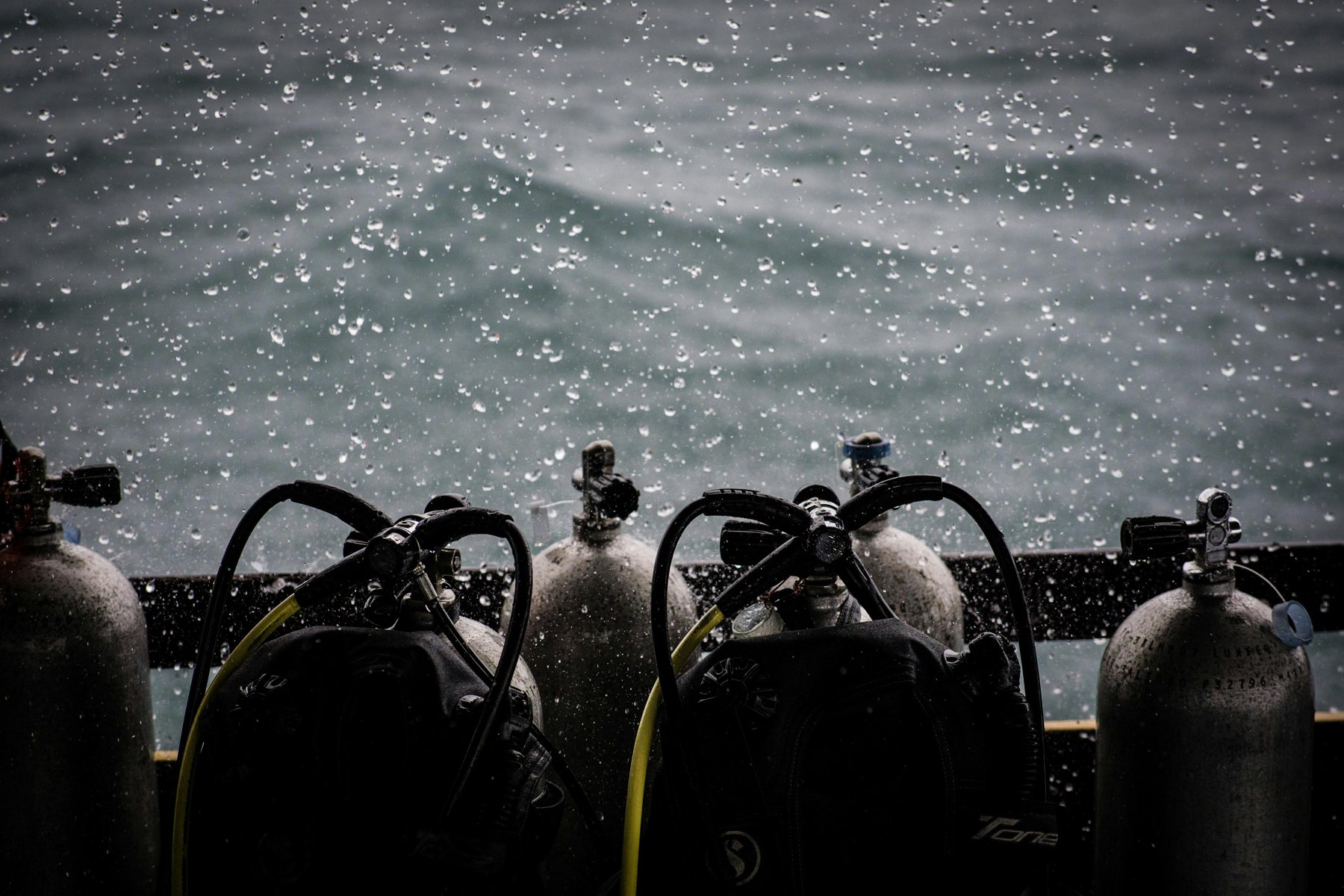 Liveaboard deck at dawn, dive tanks lined up