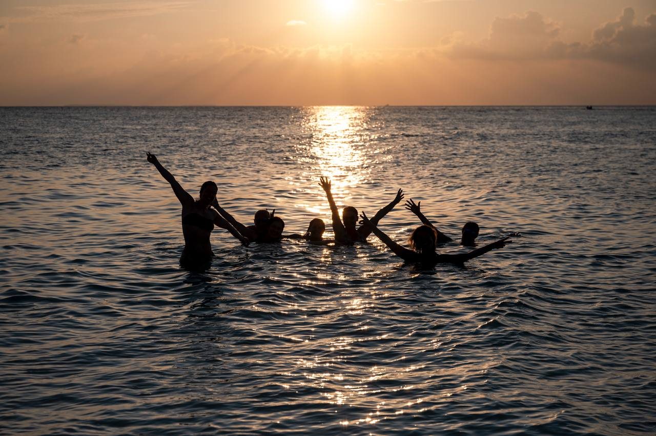 People together on deck at sunset